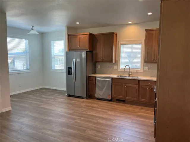 a kitchen with stainless steel appliances a refrigerator sink and cabinets