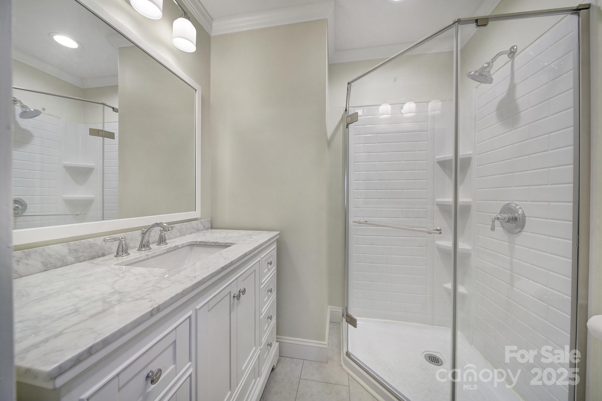 3987 Taxahaw Road Lancaster, SC 29720 - Photo 11 of 29 a bathroom with a granite countertop shower sink and mirror
