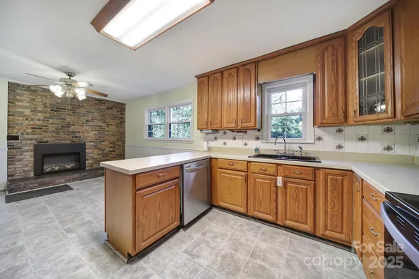 a kitchen with stainless steel appliances granite countertop a stove sink and cabinets