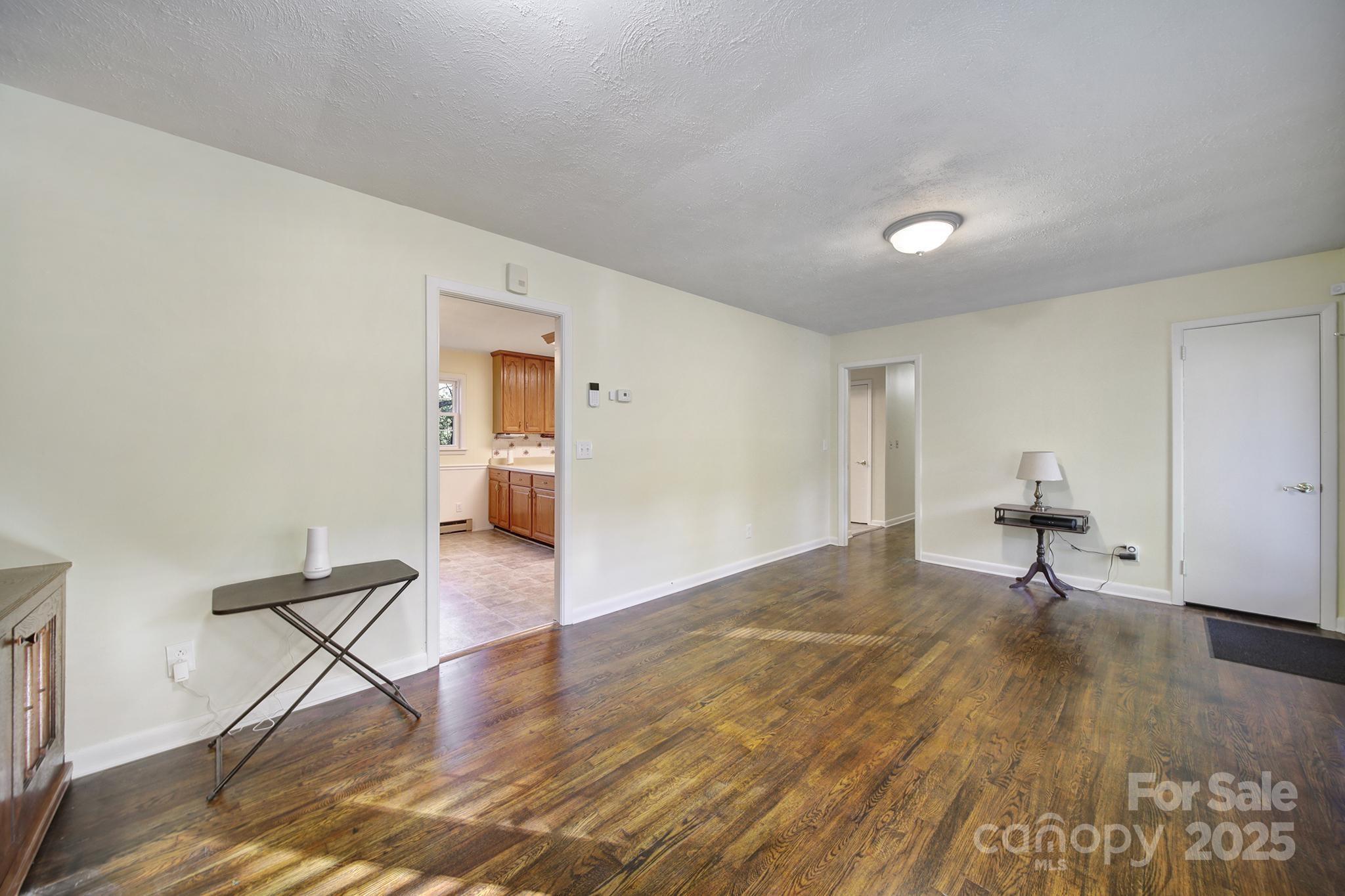 3987 Taxahaw Road Lancaster, SC 29720 - Photo 5 of 29 a view of a livingroom with wooden floor and a workspace