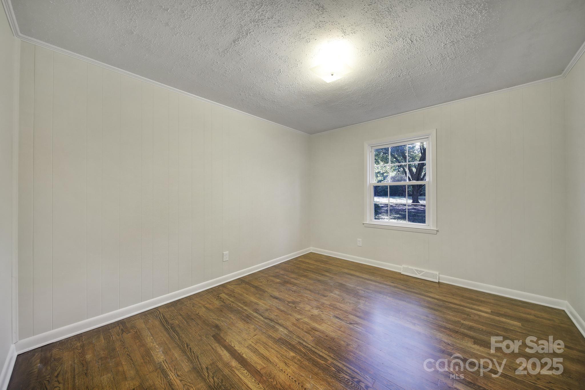 3987 Taxahaw Road Lancaster, SC 29720 - Photo 8 of 29 an empty room with wooden floor and windows