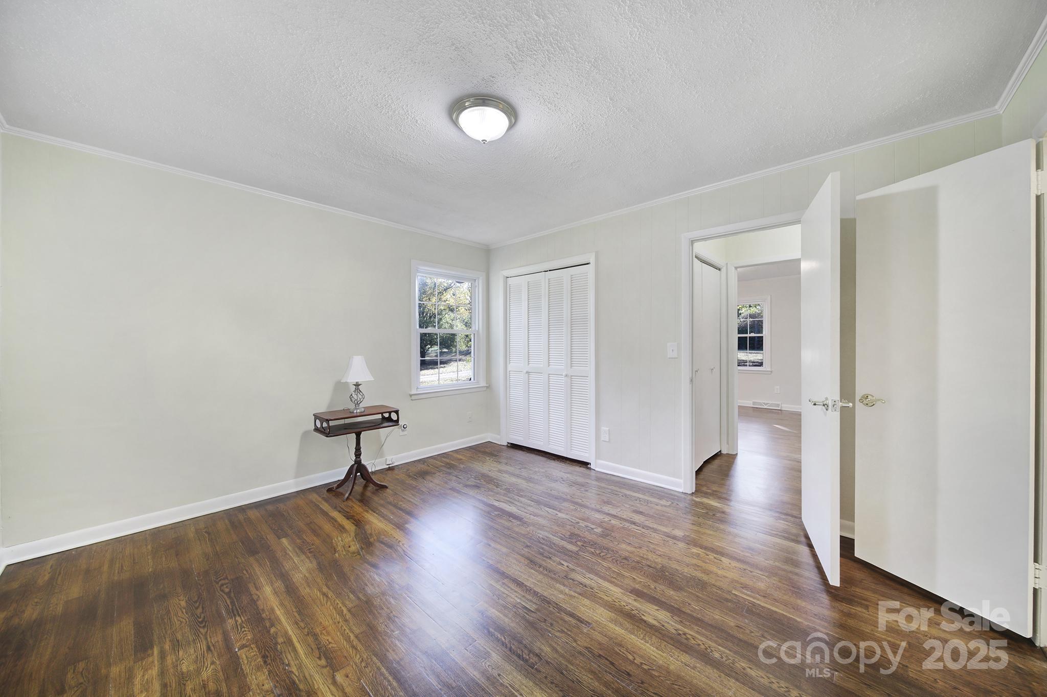 3987 Taxahaw Road Lancaster, SC 29720 - Photo 9 of 29 an empty room with wooden floor and windows