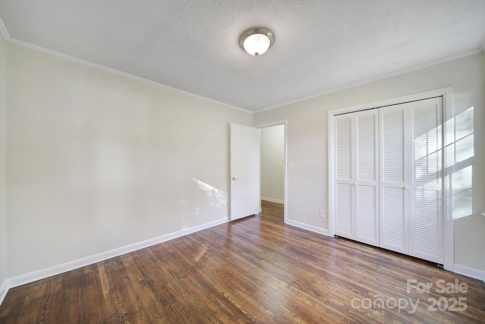 3987 Taxahaw Road Lancaster, SC 29720 - Photo 10 of 29 a view of an empty room with wooden floor and a window