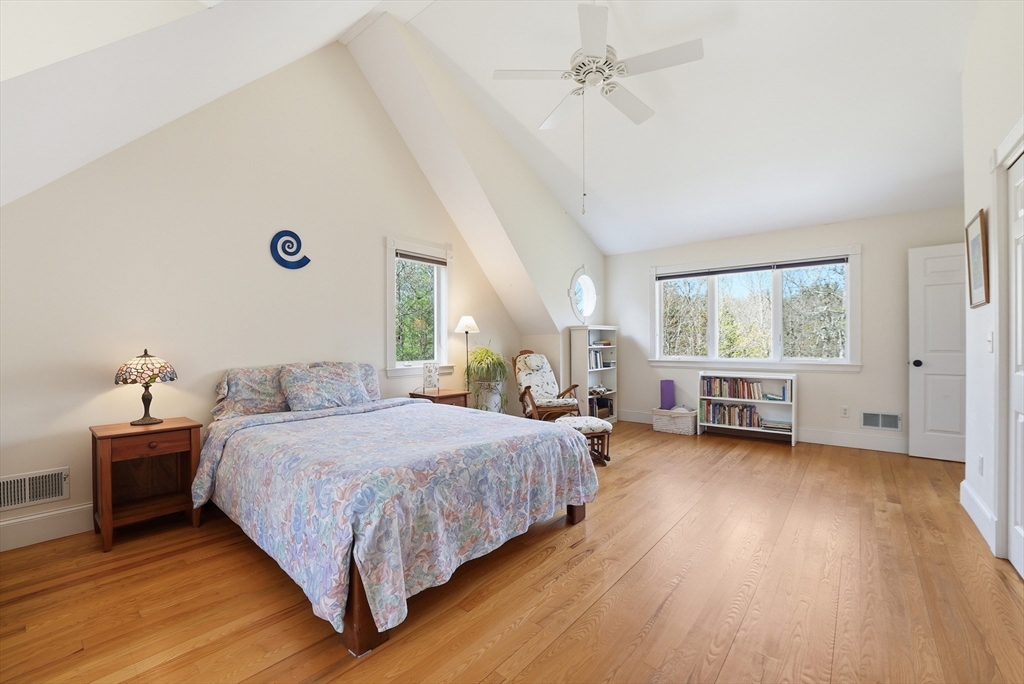 110 Turkey Hill Road Northampton, MA 01062 - Photo 17 of 42 a bedroom with a bed and a chandelier