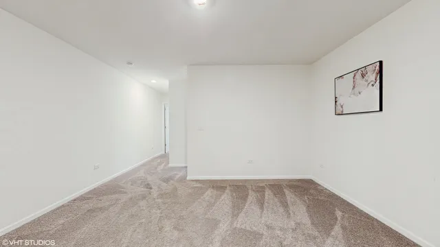 a view of empty room with ceiling fan and window
