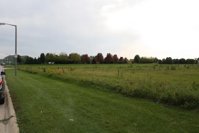 a view of a lake with houses in the background