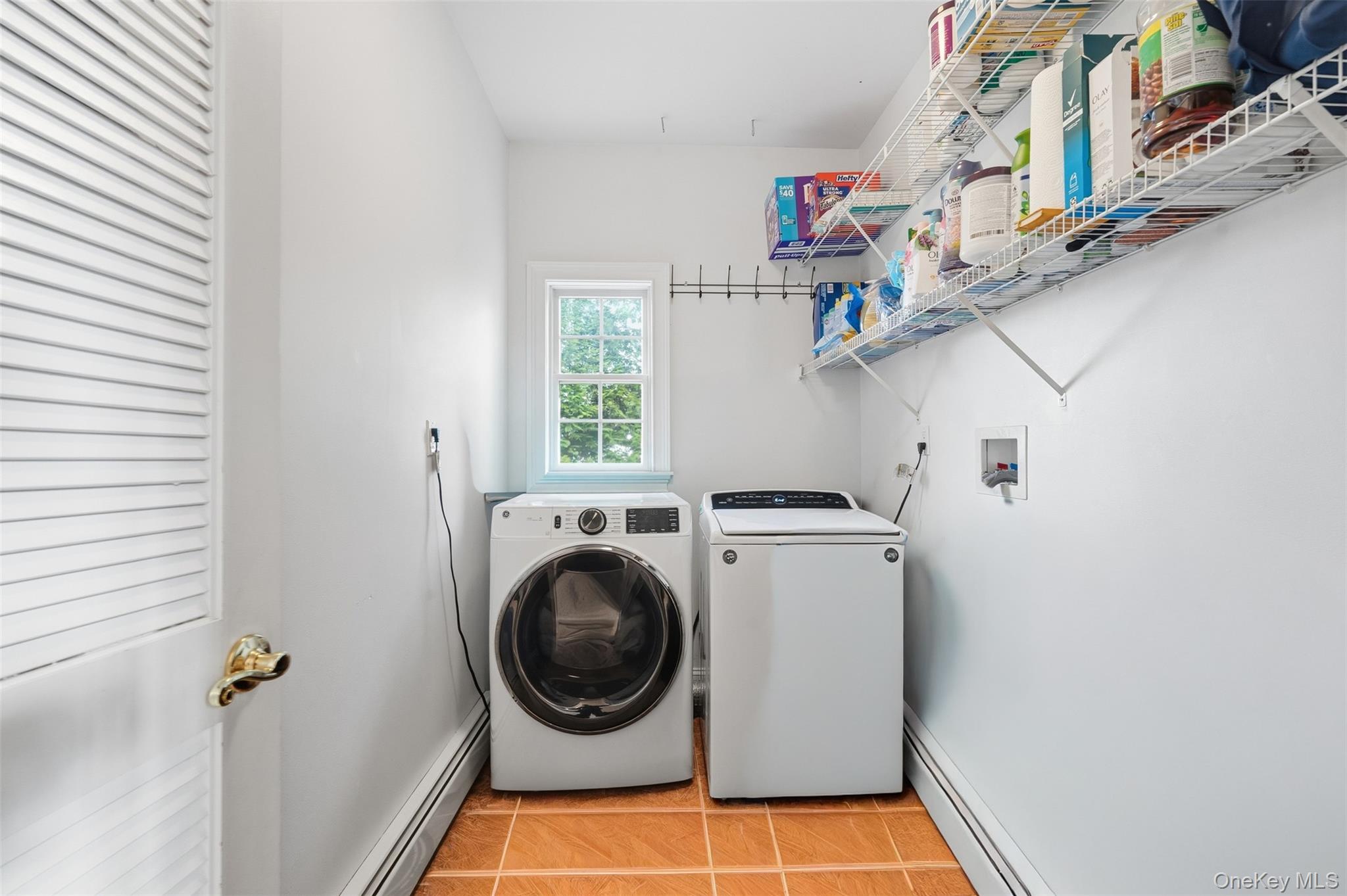 54 Pyngyp Road Stony Point, NY 10980 - Photo 13 of 28 Washroom with a baseboard heating unit, light tile patterned floors, and washing machine and dryer