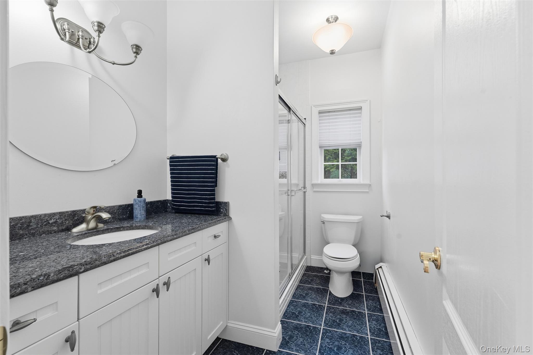 54 Pyngyp Road Stony Point, NY 10980 - Photo 14 of 28 Full bathroom with baseboard heating, vanity, a shower stall, and dark tile patterned flooring
