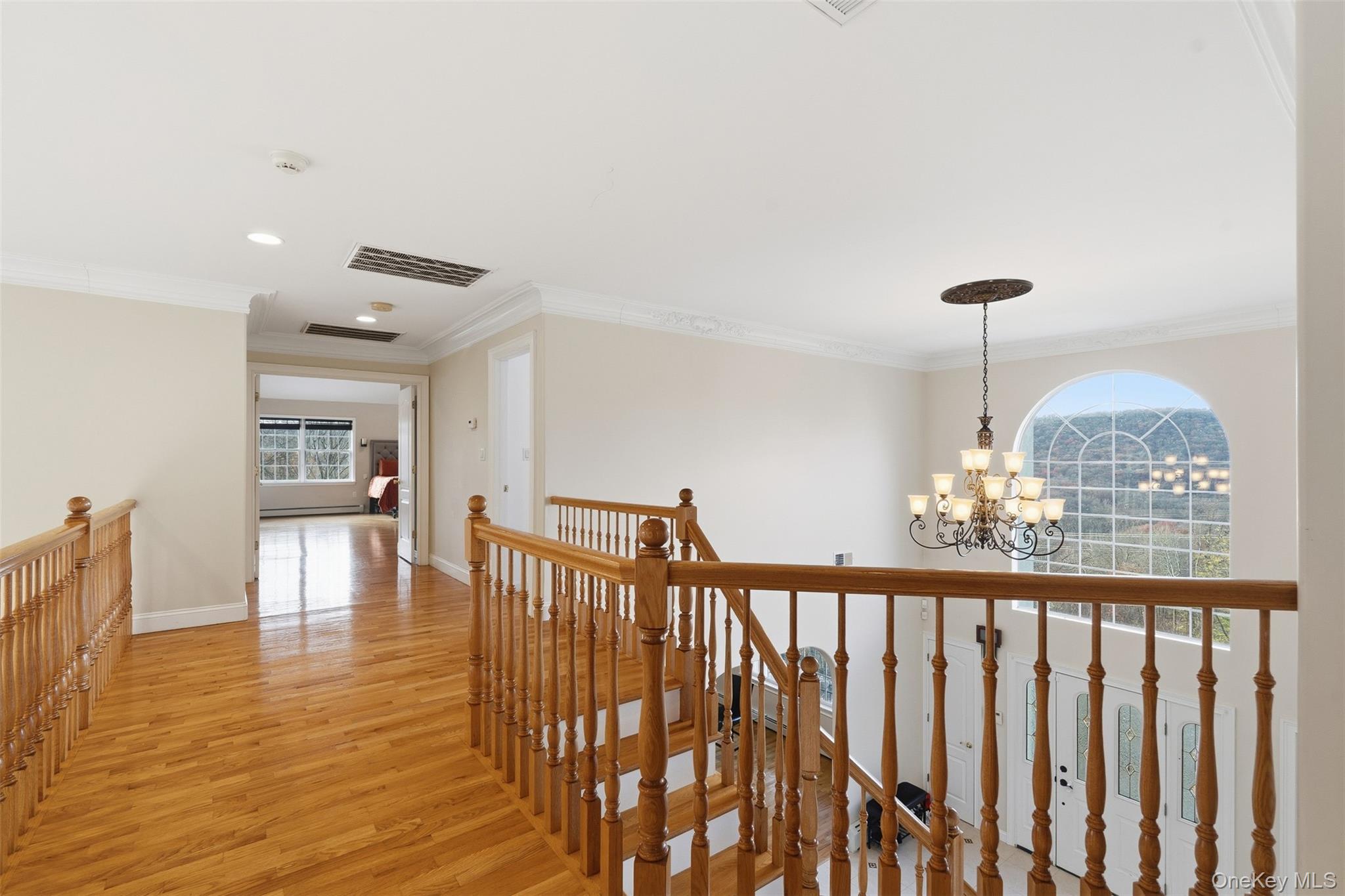 54 Pyngyp Road Stony Point, NY 10980 - Photo 21 of 28 Hallway with an upstairs landing, light wood-type flooring, ornamental molding, a chandelier, and recessed lighting