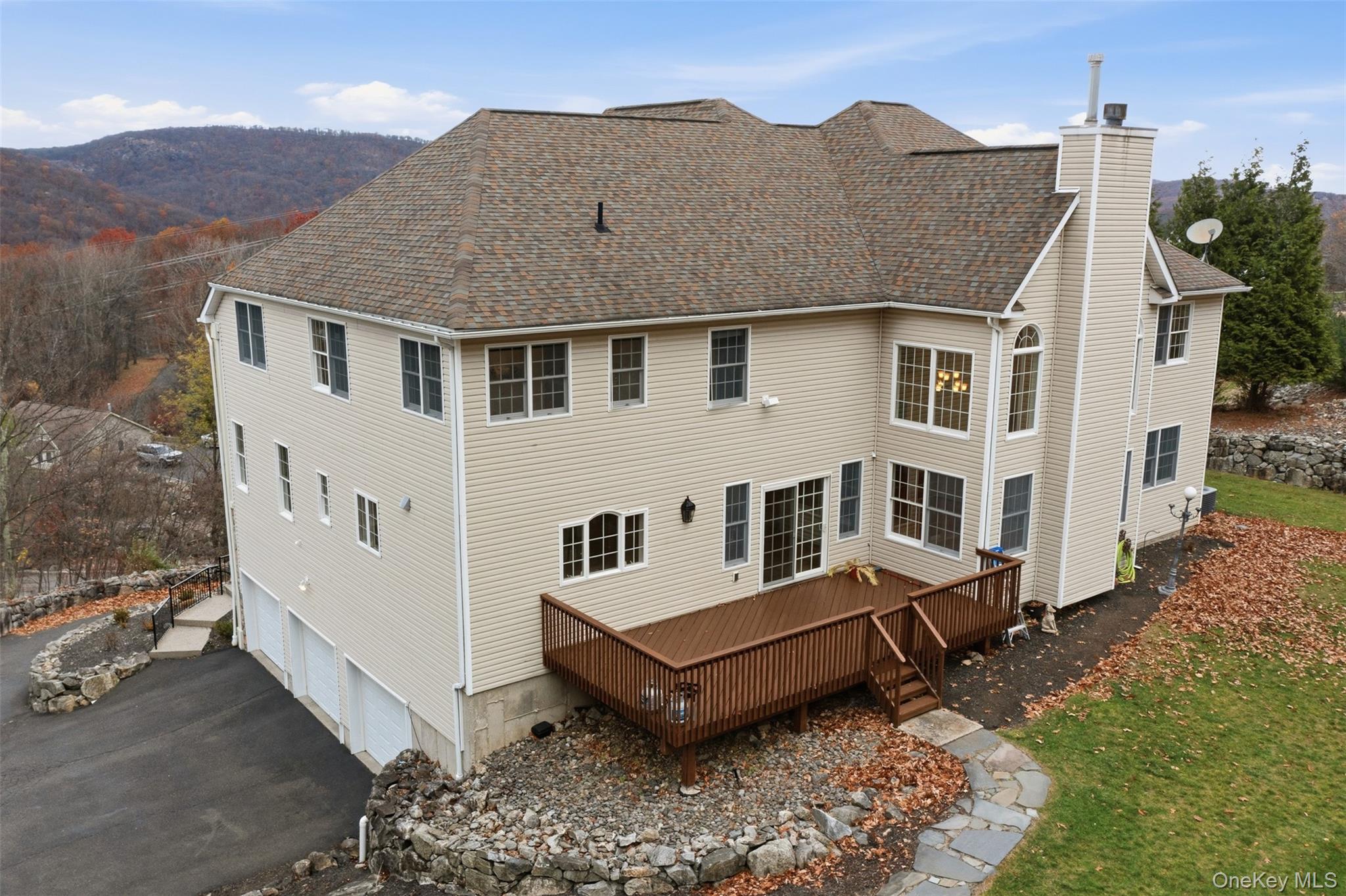 54 Pyngyp Road Stony Point, NY 10980 - Photo 4 of 28 Rear view of house with an attached garage, a deck, a chimney, asphalt driveway, and roof with shingles