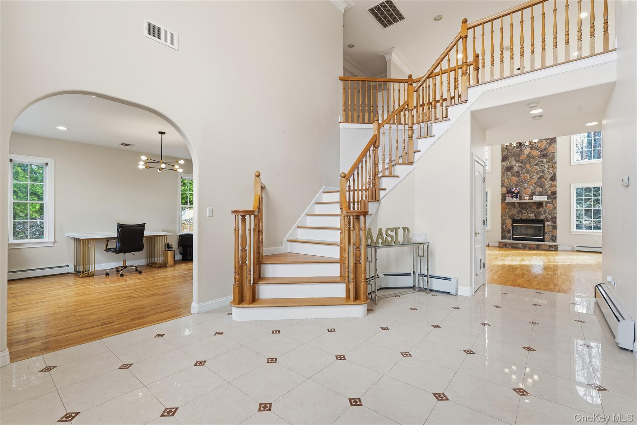 54 Pyngyp Road Stony Point, NY 10980 - Photo 5 of 28 Stairs featuring a towering ceiling, a chandelier, a baseboard radiator, tile patterned flooring, and recessed lighting
