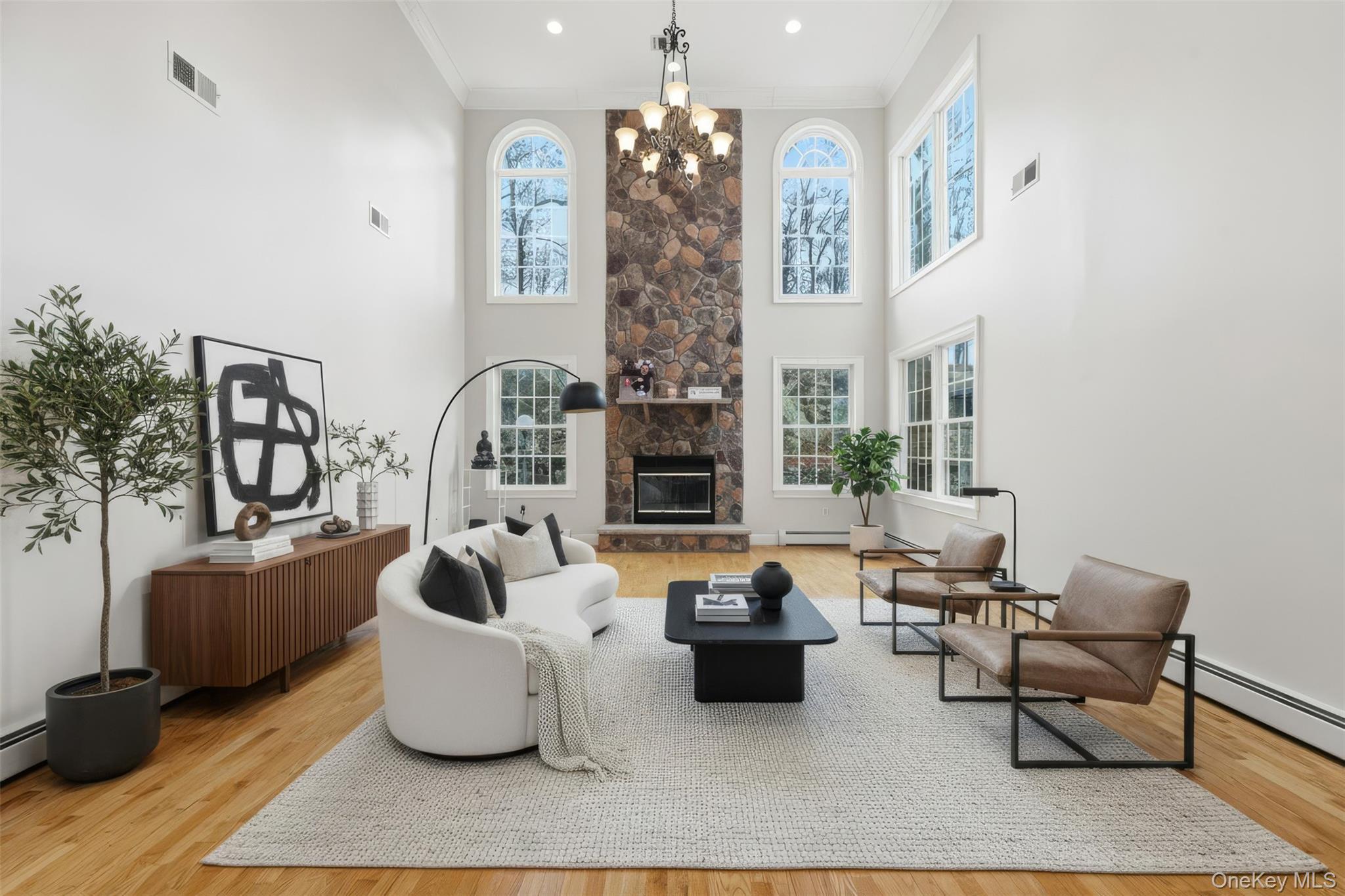 54 Pyngyp Road Stony Point, NY 10980 - Photo 8 of 28 Living area featuring plenty of natural light, light wood-style flooring, ornamental molding, and a stone fireplace