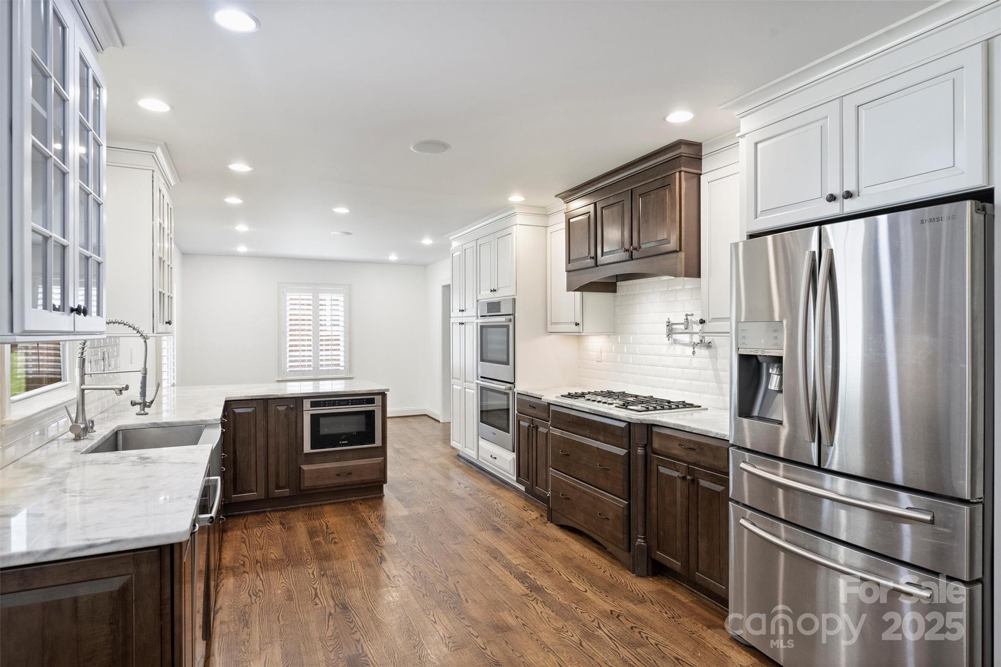 1008 Dumbarton Road Gastonia, NC 28054 - Photo 13 of 40 a kitchen with stainless steel appliances granite countertop a refrigerator sink and stove