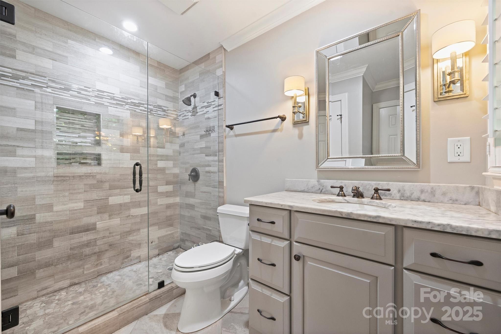 1008 Dumbarton Road Gastonia, NC 28054 - Photo 31 of 40 a bathroom with a granite countertop sink toilet a mirror and shower