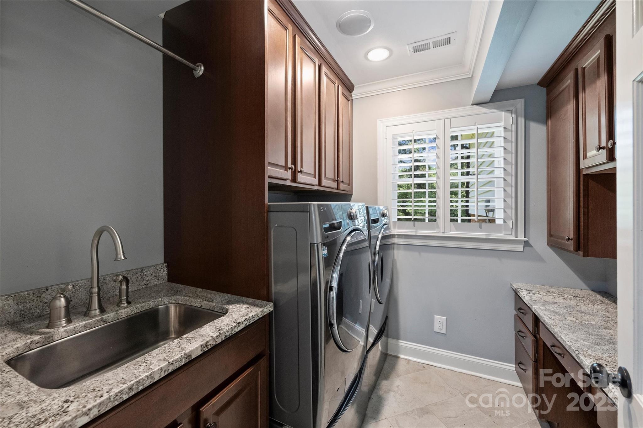 1008 Dumbarton Road Gastonia, NC 28054 - Photo 36 of 40 a kitchen with a refrigerator sink and cabinets