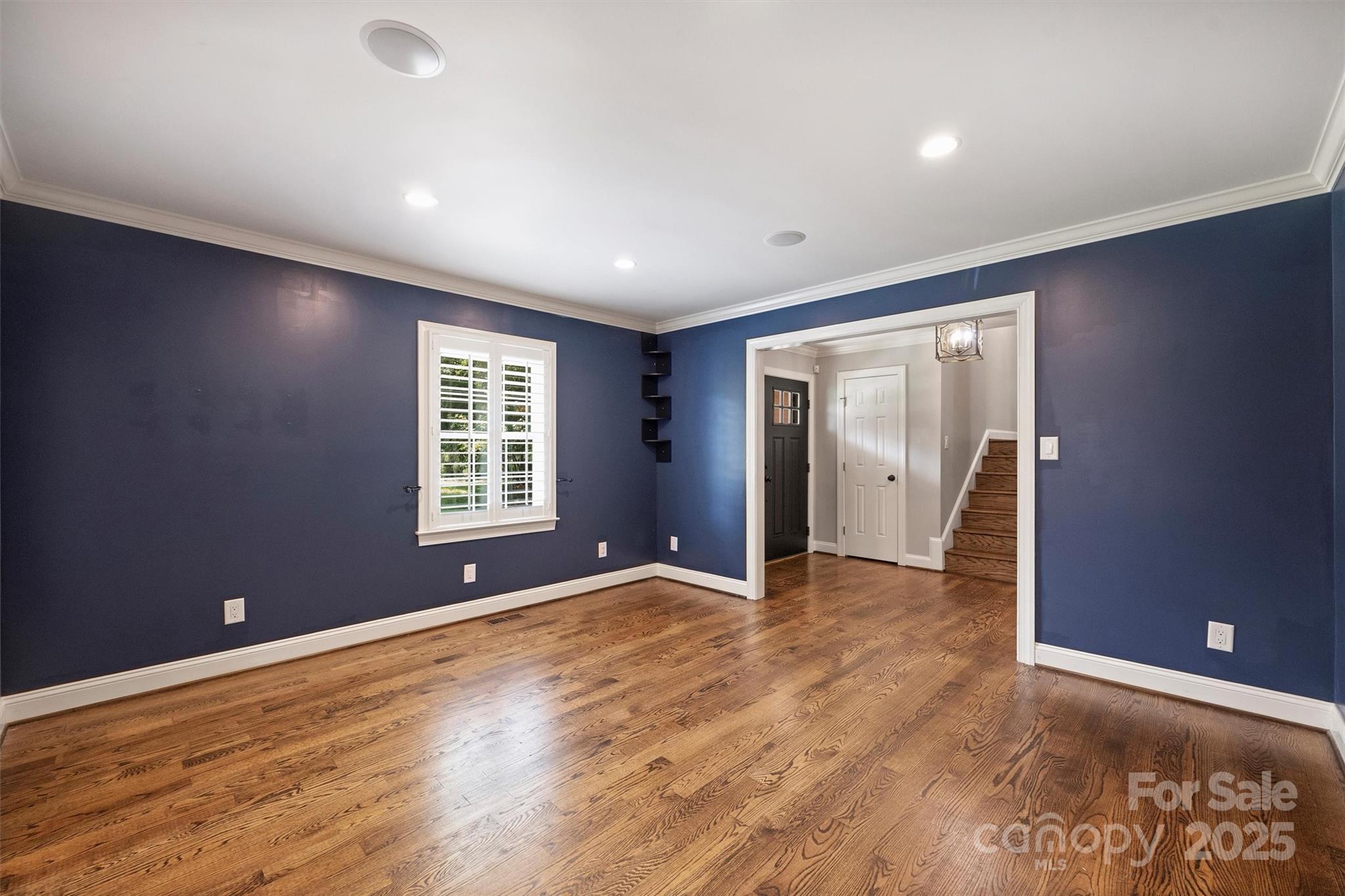 1008 Dumbarton Road Gastonia, NC 28054 - Photo 8 of 40 a view of an empty room with wooden floor and a window