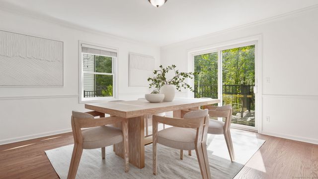 a dining room with furniture and wooden floor