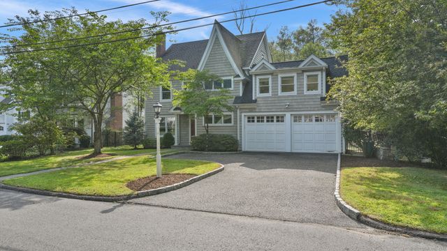 a view of a house with a swimming pool and a yard