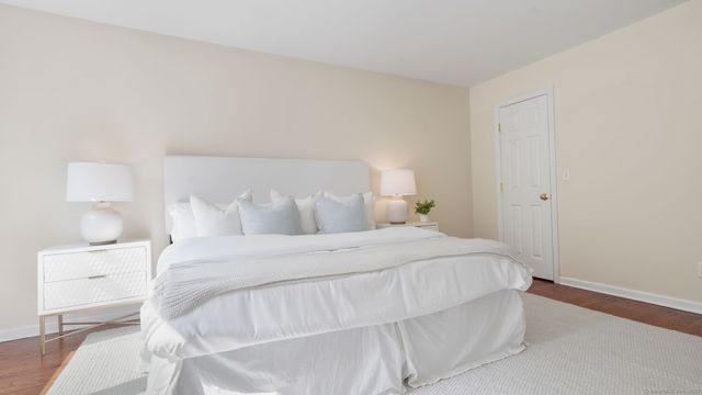 a bedroom with a bed and a night stand