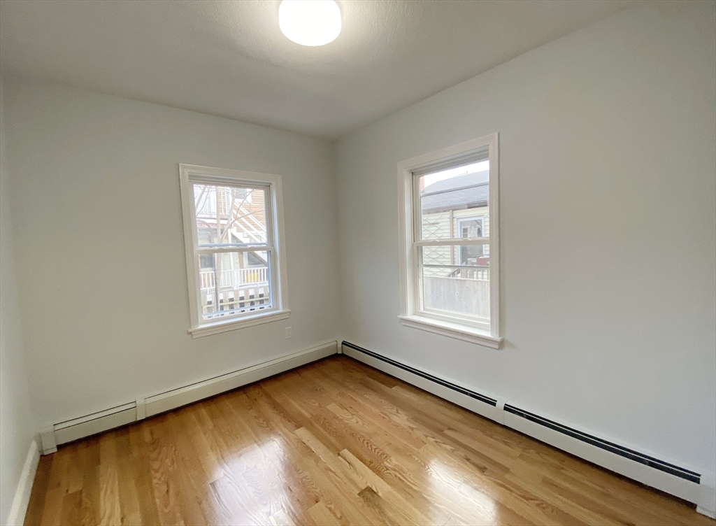 7 Sumner Place, Unit 1 Boston, MA 02128 - Photo 4 of 8 a view of an empty room and a window