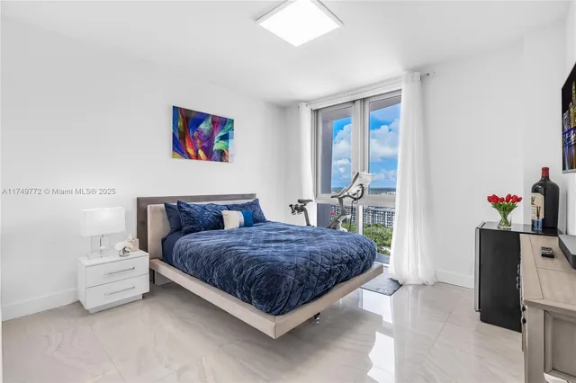 a living room with stainless steel appliances kitchen island granite countertop a sink and cabinets