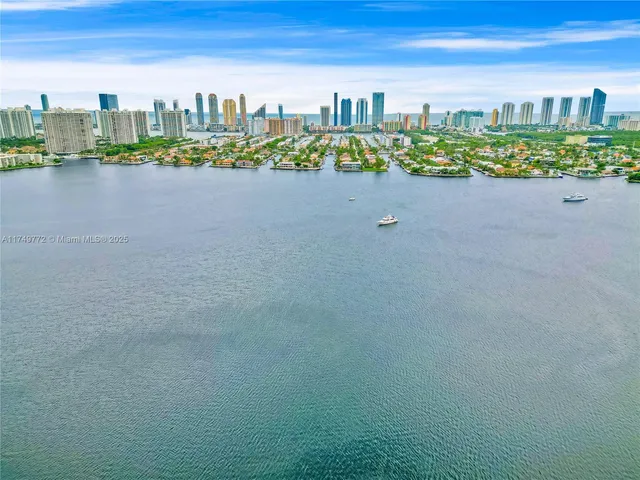 a living room with furniture a flat screen tv and a floor to ceiling window