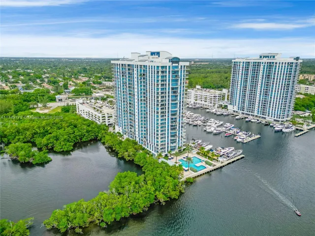 a dining room with furniture a chandelier and wooden floor