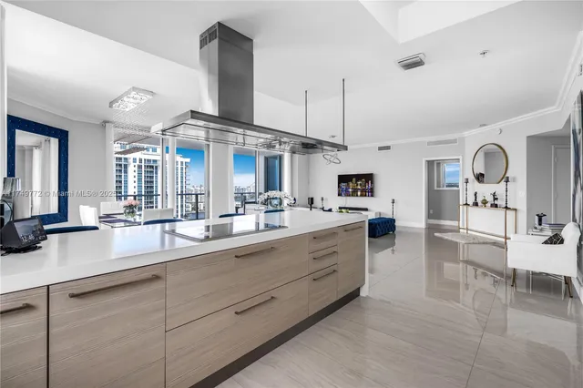 a living room with furniture a flat screen tv and a floor to ceiling window