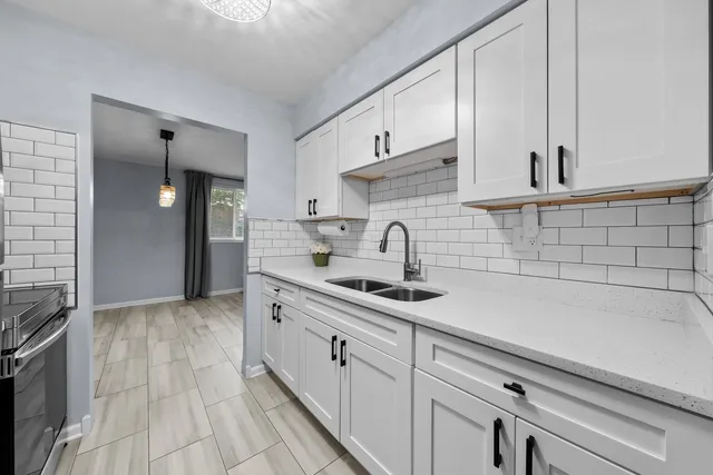 a kitchen with a sink and cabinets