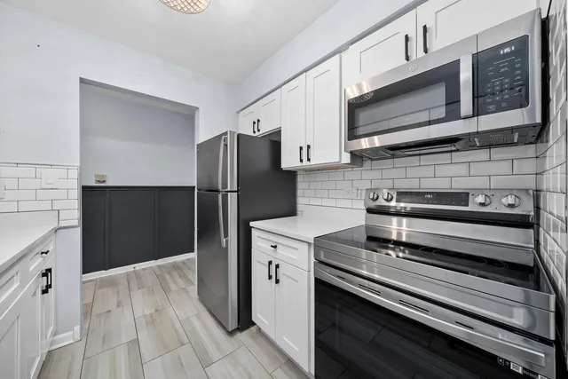 a kitchen with a refrigerator stove and microwave