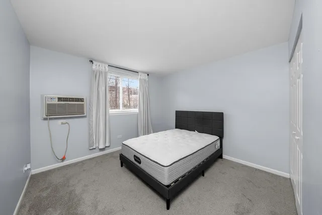 a bedroom with a bed lamp and window