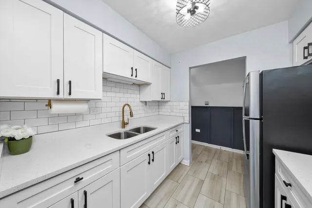 a kitchen with a sink appliances and cabinets