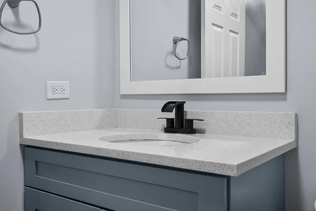 a bathroom with a sink and a mirror