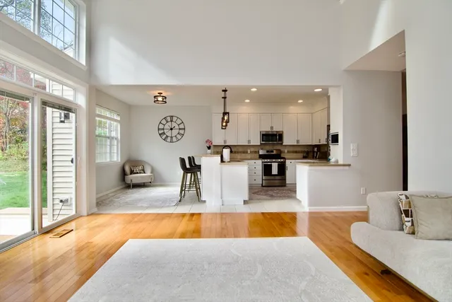 a large kitchen with stainless steel appliances granite countertop a sink and cabinets