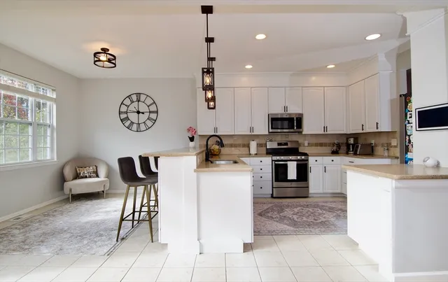 a kitchen with a refrigerator and a stove top oven