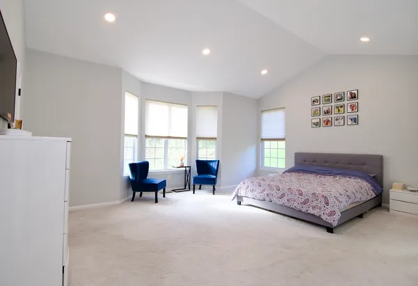a bedroom with a bed and a couch