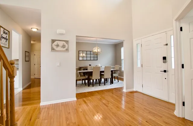 a view of a room with wooden floor and furniture