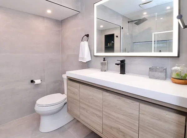 a bathroom with a toilet a sink and shower