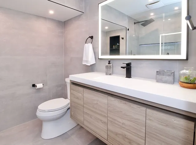 a bathroom with a toilet a sink and shower
