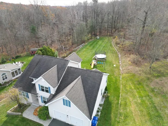 an aerial view of a house with swimming pool garden and patio