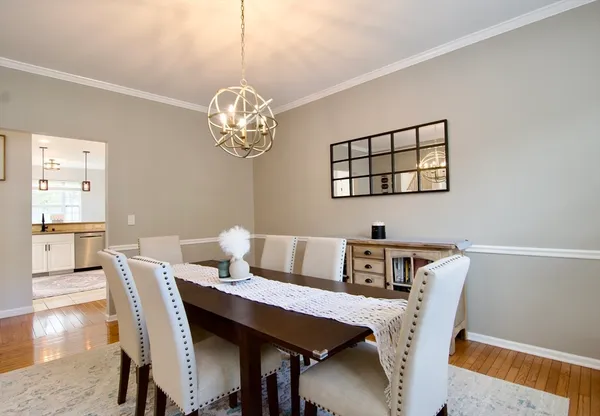 a view of a dining room with furniture wooden floor and chandelier