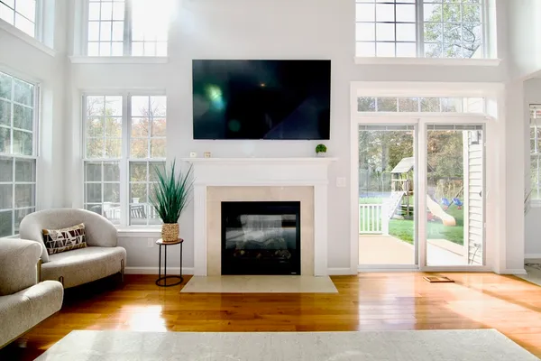 a living room with furniture a flat screen tv and a fireplace