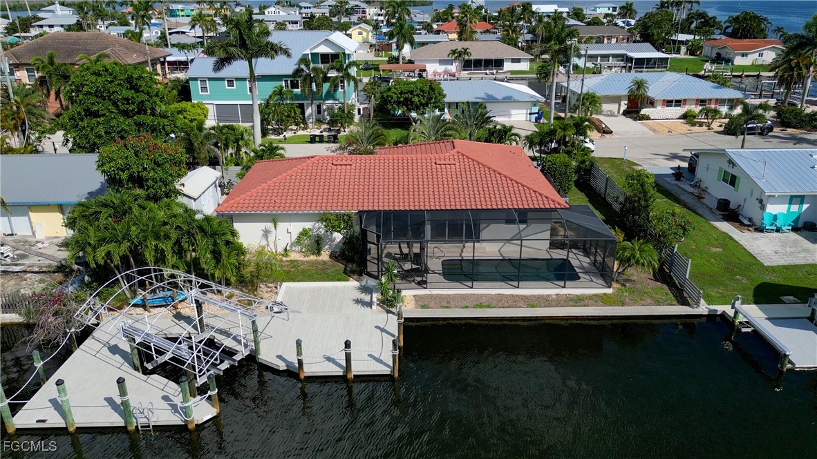 an aerial view of a house with swimming pool patio and outdoor seating