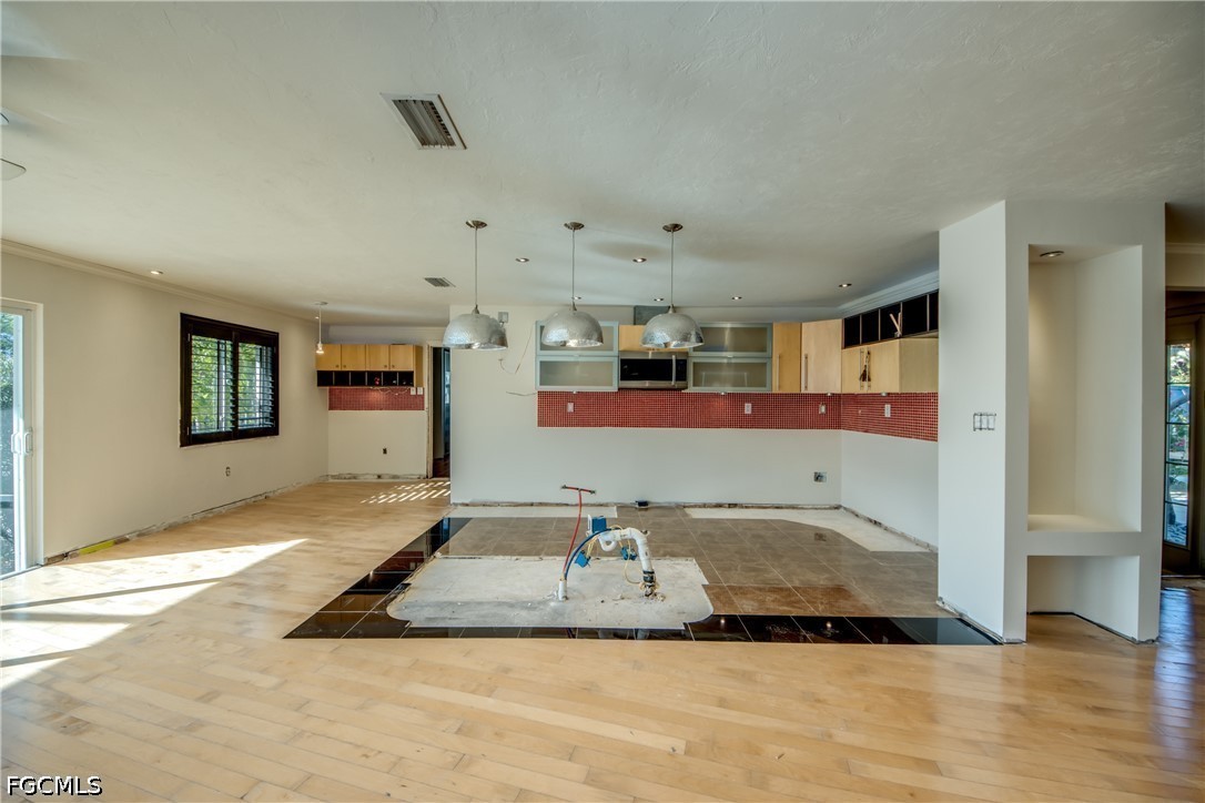 2701 Bruce Street Matlacha, FL 33993 - Photo 20 of 47 a view of a livingroom with wooden floor and kitchen space