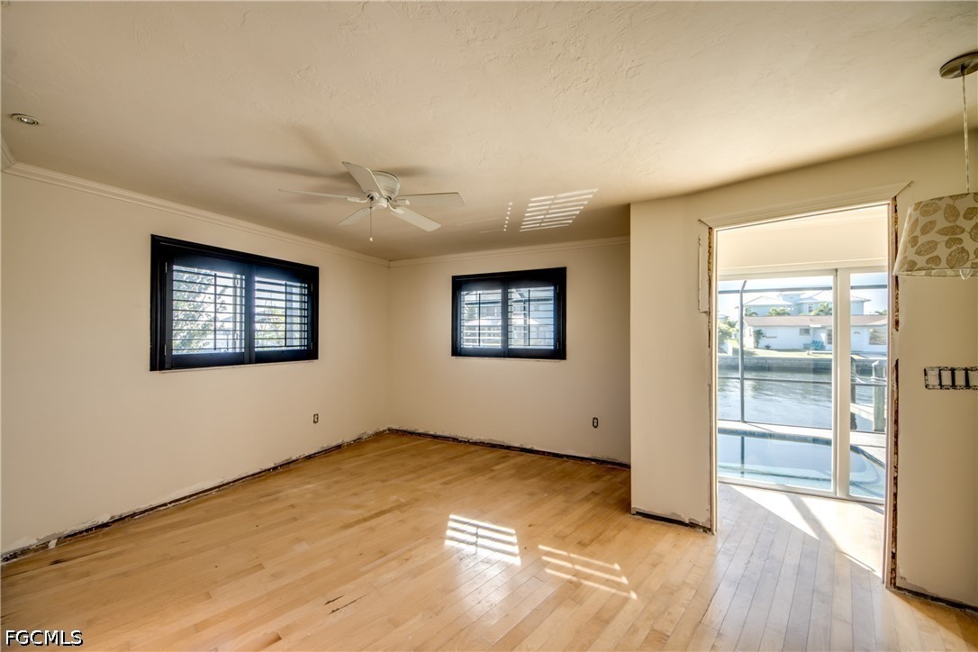 2701 Bruce Street Matlacha, FL 33993 - Photo 26 of 47 a view of an empty room with a window and wooden floor