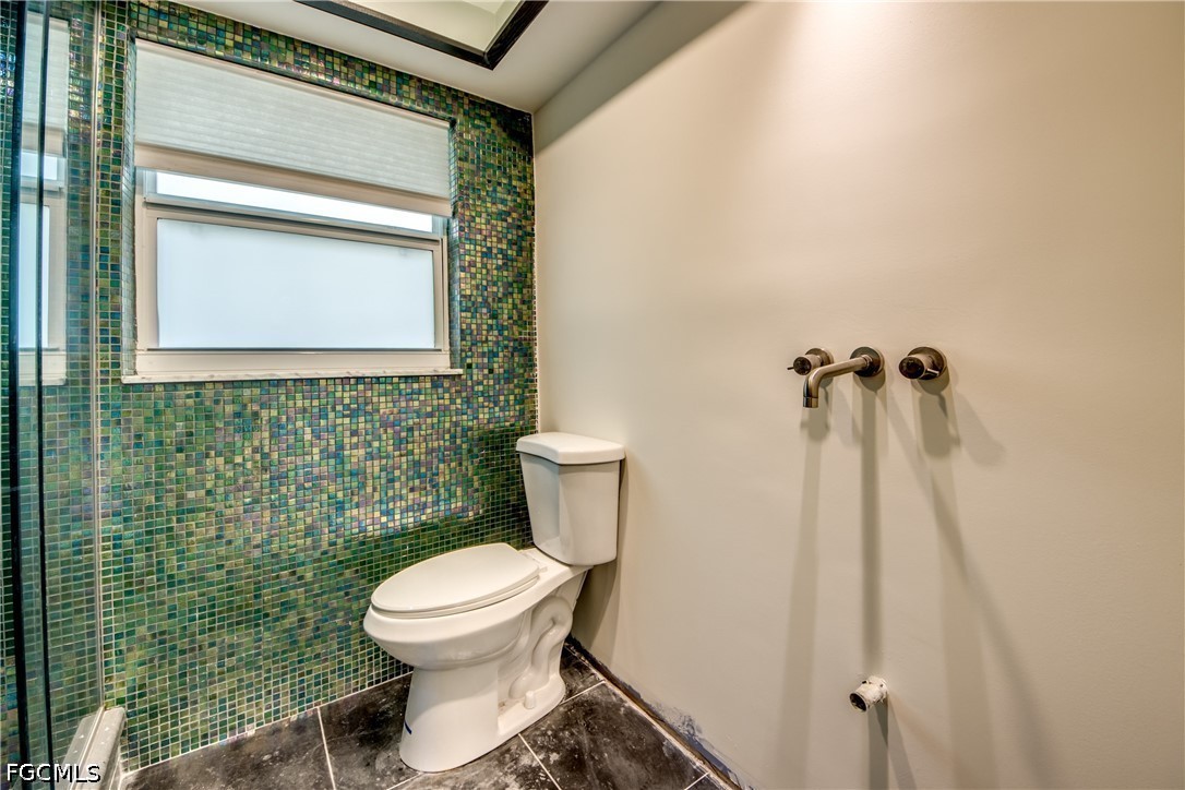 2701 Bruce Street Matlacha, FL 33993 - Photo 31 of 47 a bathroom with a toilet and a shower