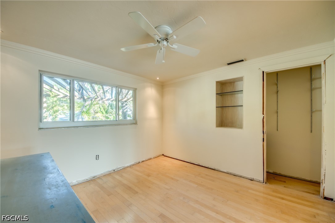 2701 Bruce Street Matlacha, FL 33993 - Photo 34 of 47 a view of an empty room with wooden floor and a window