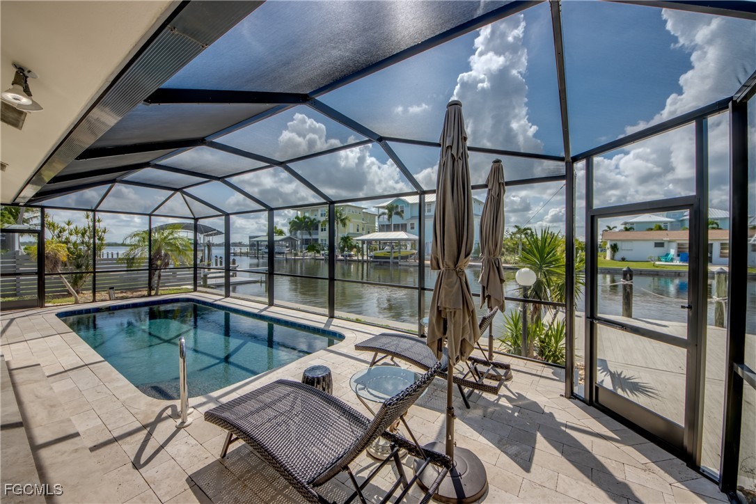 2701 Bruce Street Matlacha, FL 33993 - Photo 36 of 47 a patio with yard glass top table and chairs
