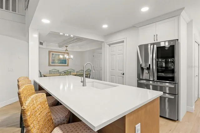a spacious bathroom with a granite countertop sink a mirror a vanity and a shower