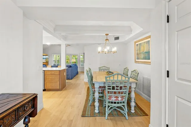 a living room with furniture a fireplace and a chandelier